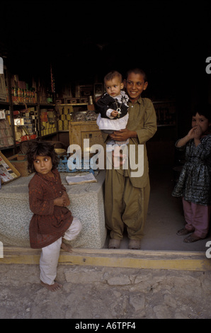 Afghanistan, Western Afghanistan, Herat, Afghani children in their family's shop front in Herat Stock Photo