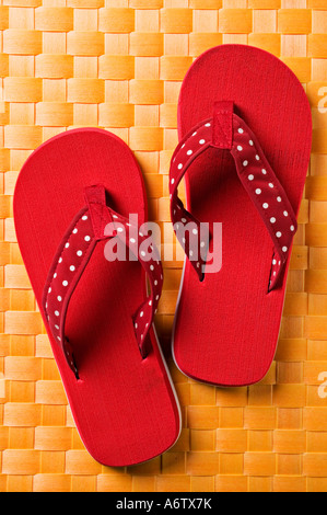 Pair of red sandals on yellow matt Stock Photo