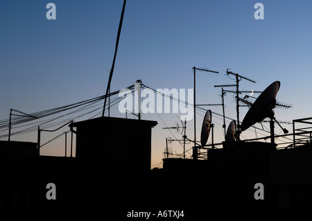 Satellite dishes and television antennas in the evening light Stock Photo