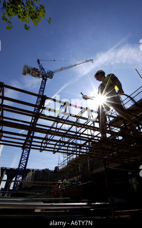 One builder working on the steel foundations of a new affordable home Stock Photo