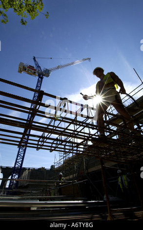 One builder working on the steel foundations of a new affordable home Stock Photo