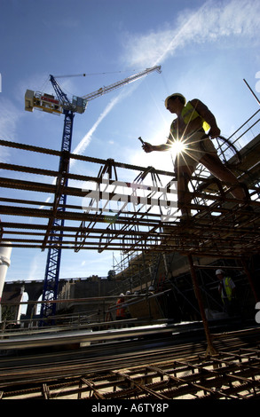 One builder working on the steel foundations of a new affordable home Stock Photo