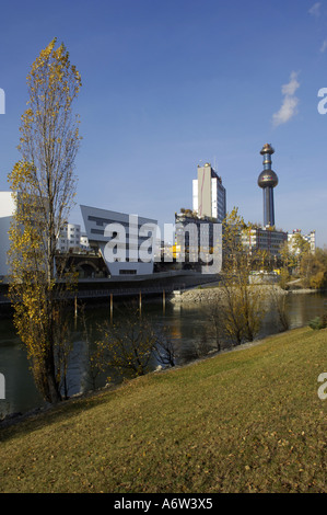 modern building of Zaha Hadid on the Danube channel waste incinerating plant Spittelau of Hundertwasser in the back Stock Photo