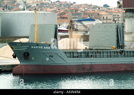 Sete port bulk carrier freighter at dockside during unloading of dusty material possibly sand or grain Stock Photo