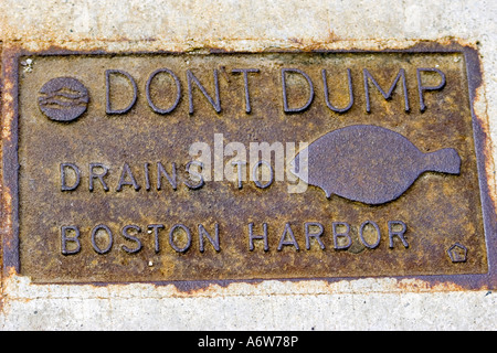 rusty DON T DUMP Drains to Boston Harbor plaque on Boston sidewalk Stock Photo