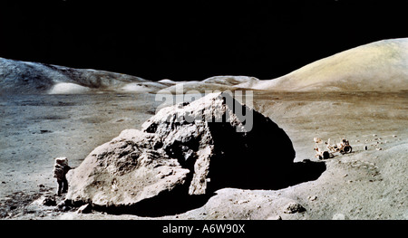 Surface of the Moon Apollo 17 the last Lunar Landing Mission - Dr Harrison Schmitt working by Tracy's Rock During EVA 3 with Lunar Rover Vehicle Stock Photo