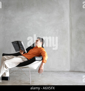 Man reading magazine Stock Photo