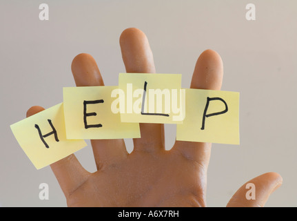 human hand with post it notes spelling HELP on fingers Stock Photo