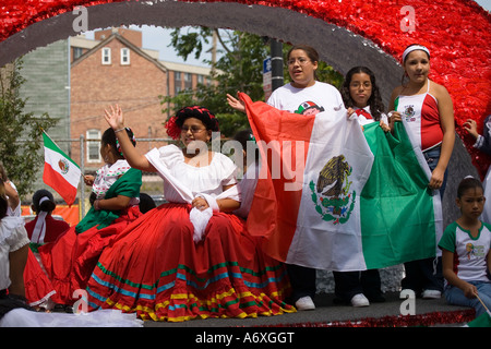 ILLINOIS Chicago Girls hold flags ride decorated float in Mexican Independence Day Parade on 18th Street Stock Photo