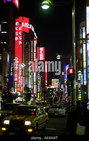 vertical people and traffic in street scene in shinjuku tokyo at night japan Stock Photo