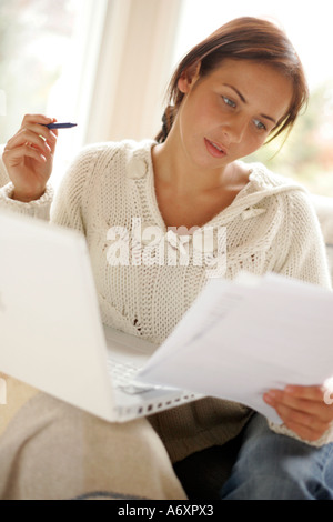 Woman working out finances online Stock Photo