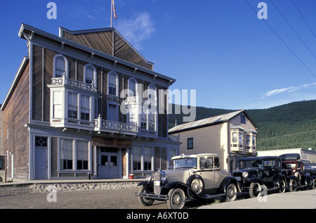 North America, Canada, Yukon, Dawson City. Antique cars along street in gold rush town Stock Photo