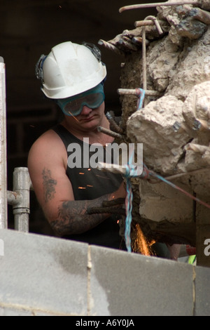 Man using angle grinder on re inforced concrete during building redevelopment Bradford Stock Photo