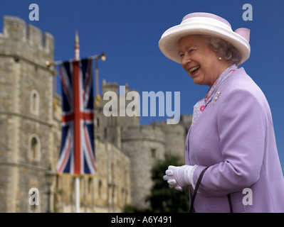 QUEEN ELIZABETH II Windsor Castle exterior happy smiling HRH Queen Elizabeth II in grounds of Windsor Castle Union Jack flag behind UK (also 2HG5K5F) Stock Photo