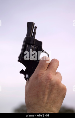 Man holding a starting gun Stock Photo