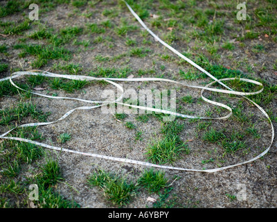 Tape measure unraveled on grass Stock Photo - Alamy