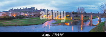 Carcassonne. Languedoc. View over the old city. The old bridge across the Aude river. Illuminated in early morning. A rainy and Stock Photo