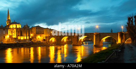 The gothic St Martin Church and the bridge across the l'Aude river. Town of Limoux. Limoux. Languedoc. Aude river. Illuminated at evening time and night. France. Europe. Stock Photo