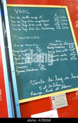 Calk board with wines for sale: Vrac, bulk, table wine, Vins de Pays d'Oc, wine in bottle, Vin de Pays d'Oc and AOC, and BiB bag in box. Domaine Le Nouveau Monde. Terrasses de Beziers. Languedoc. France. Europe. Stock Photo