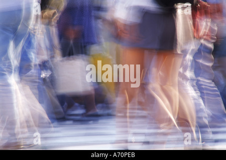 Legs in motion at city crosswalk in Tokyo Stock Photo