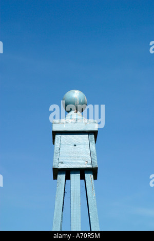 Blue painted wooden garden obelisk against clear blue sky in Spring in UK Stock Photo