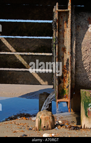 Sewage pipe outlet on Sussex beach at low tide Stock Photo