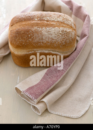 Fresh white loaf with linen towel on painted wooden background - high end Hasselblad 61mb digital image Stock Photo