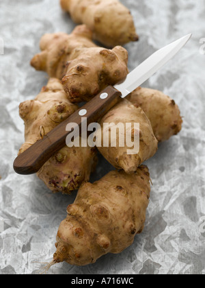 Jerusalem artichokes on worktop with vegetable knife - high end Hasselblad 61mb digital image Stock Photo