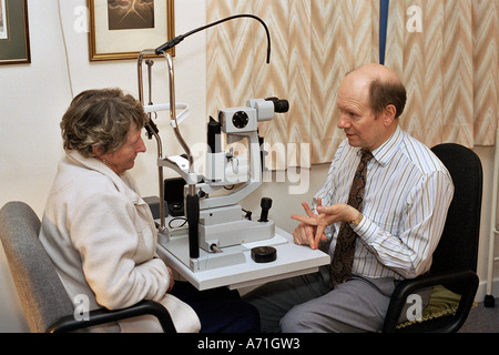 An optometrist in discussion with a patient at a medical health centre, London, UK, 5/2004. Stock Photo
