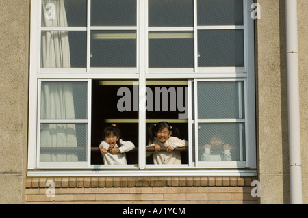 Children looking out of window at school Stock Photo