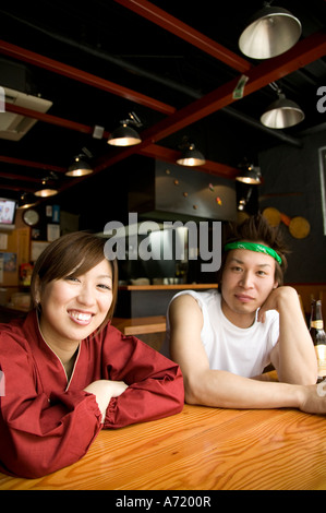 Young man and woman sitting at table Stock Photo