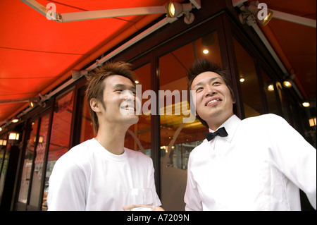 Two waiters standing in front of coffee shop Stock Photo