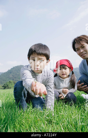 Family catching insects in meadow Stock Photo - Alamy