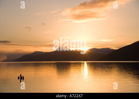 Warm sunset light over Loch Ness on a tranquil winter evening Dores near Inverness Scotland Stock Photo