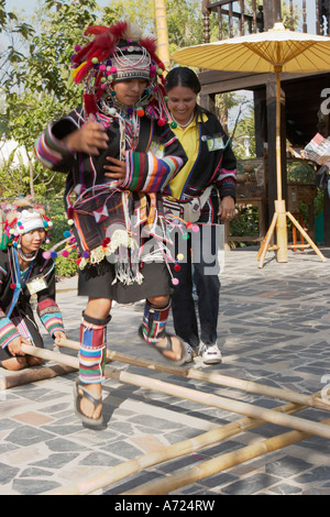 Young girls in Akha tribe traditional costumes dancing. Chiang Mai, Thailand. Stock Photo