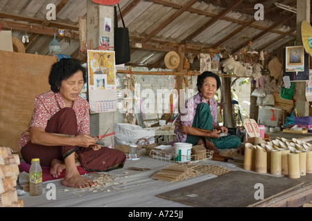 Local women making traditional umbrellas at Bo Sang village. Chiang Mai, Thailand. Stock Photo