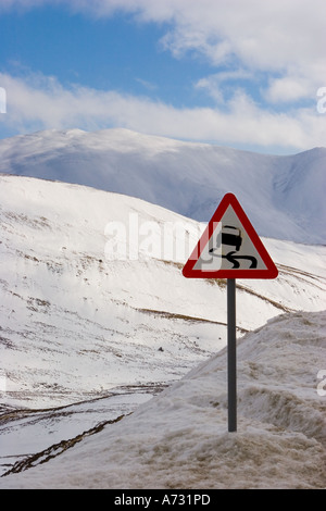 Warning Traffic Sign Slippery road ahead & frozen surfaces with of danger Ice, Spittal of Glen Shee Braemar, Cairngorms National Park Scotland uk Stock Photo