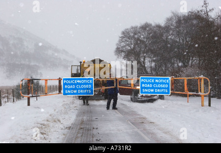 Chained Snow gates & access road closed sign; A93 Braemar, Glenshee, Blairgowrie road after winter blizzard, Cairngorms National Park, Scotland uk Stock Photo