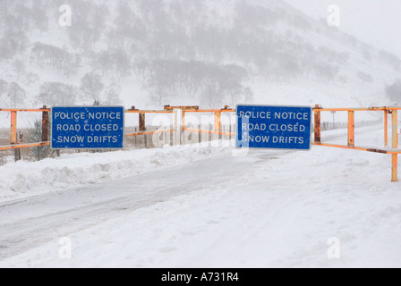 Chained Snow gates & access road closed sign; A93 Braemar, Glenshee, Blairgowrie road after winter blizzard, Cairngorms National Park, Scotland uk Stock Photo