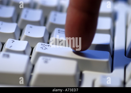 Finger clicking on computer keyboard Stock Photo