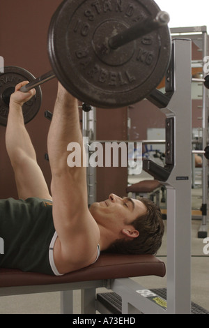 Young man lifting dumbbell Stock Photo