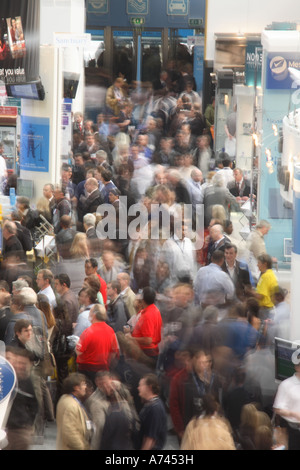 looking down busy aisle of trade show Stock Photo