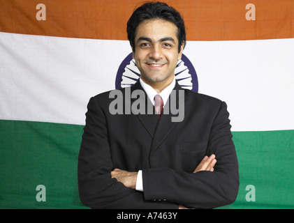 VDA 201916 South Asian Indian executive standing with cross hands pose in front of flag of india in background MR 702A Stock Photo