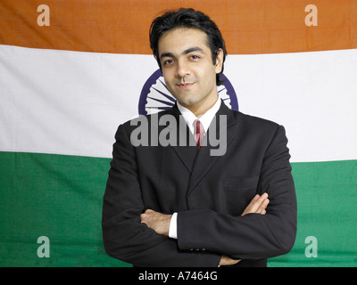 VDA 201917 South Asian Indian executive standing with cross hands pose in front of flag of india in background MR 702A Stock Photo