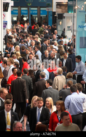 looking down busy aisle of trade show Stock Photo