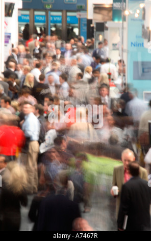 looking down busy aisle of trade show Stock Photo