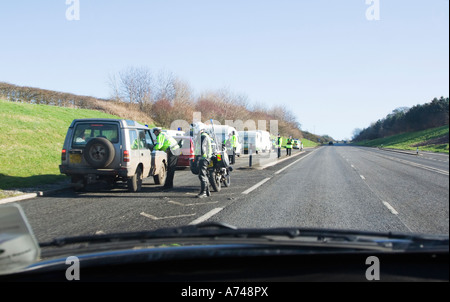 Police check point. Side of the road. View from a passing car. UK. Stock Photo