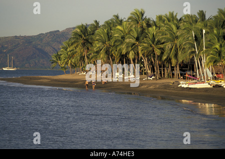 SOUTH PACIFIC, Fiji Couple walking on shoreline Stock Photo