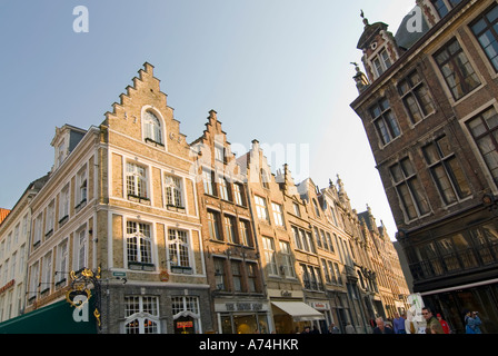 Horizontal view of the beautiful gabled shops on the corner of Steenstraat and the Markt [Market Place] on a sunny day in Bruges. Stock Photo