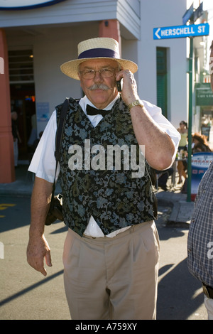 Man in 1930s clothes using mobile phone Art Deco weekend Napier North Island New Zealand Stock Photo